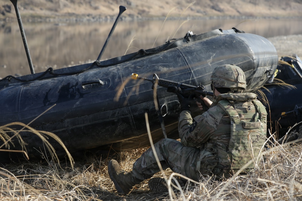 Soldier pulls security next to a Zodiac