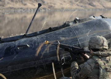 Soldier pulls security next to a Zodiac