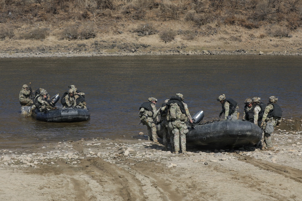 Soldiers paddle Zodiac boats