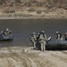 Soldiers paddle Zodiac boats
