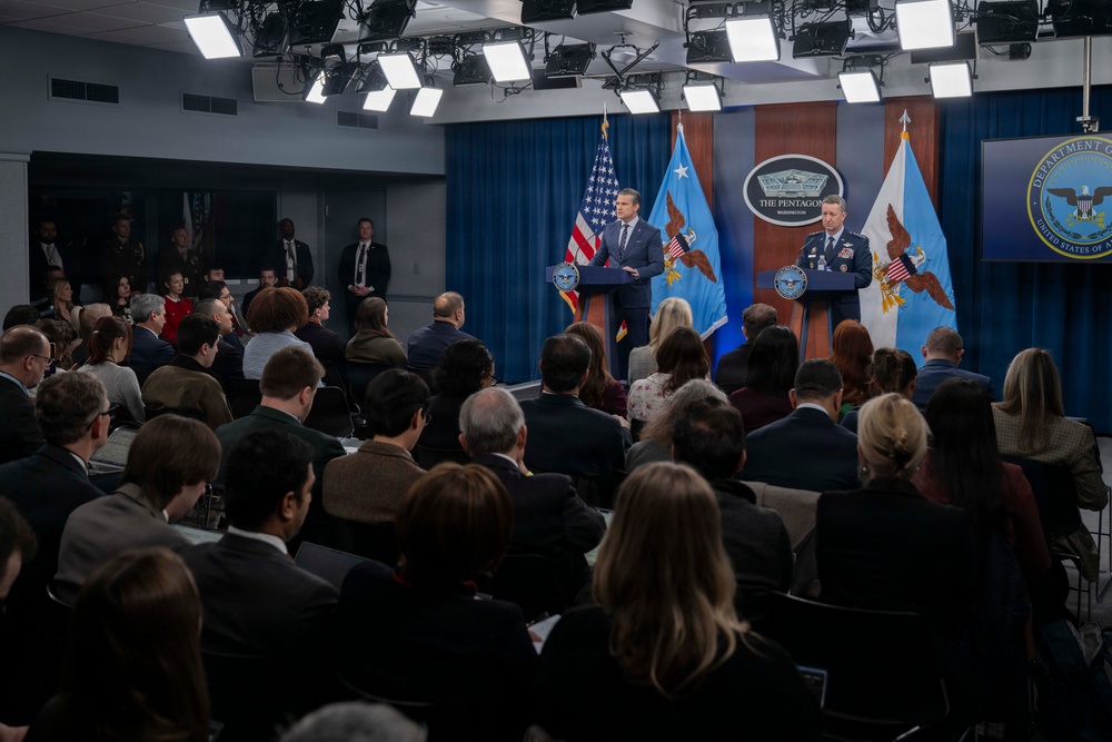 Secretary of War Pete Hegseth and Chairman of the Joint Chiefs General Dan Caine at the Pentagon podium during an Operation Epic Fury press briefing