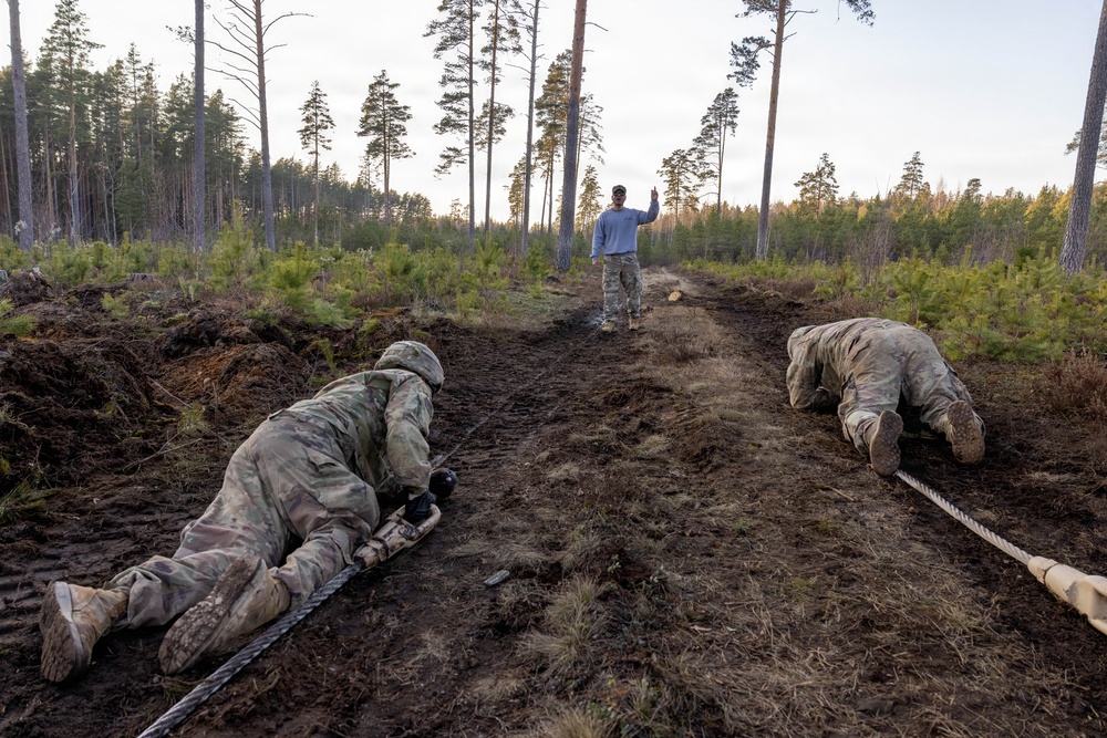 6-9 CAV Soldiers crawl through an Armor Crewman Proficiency Test