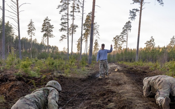 6-9 CAV Soldiers crawl through an Armor Crewman Proficiency Test