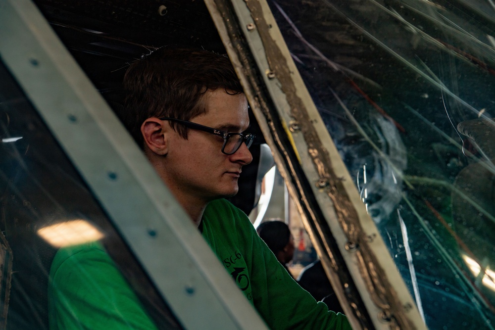Sailor Conducts Helicopter Maintenance