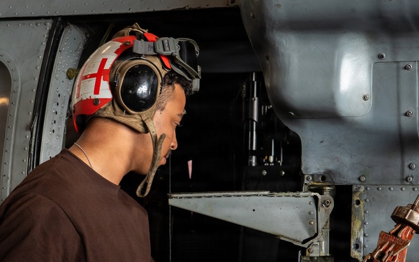 Sailor Conducts Helicopter Maintenance