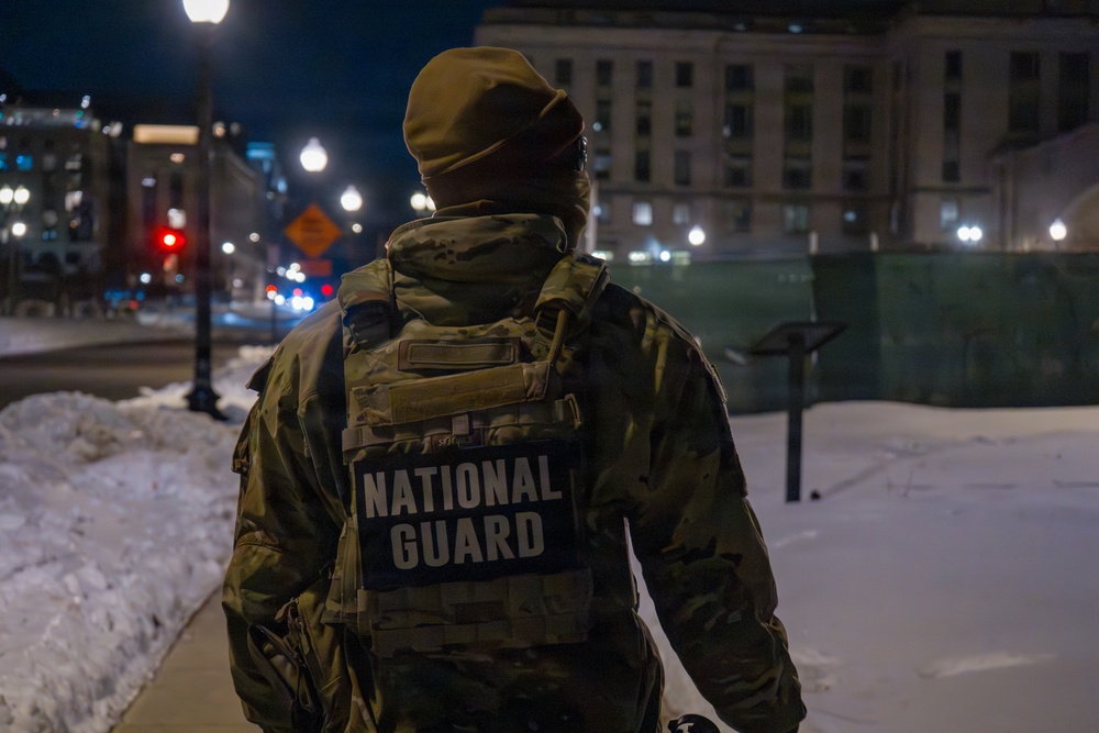 A Joint Task Force Magnolia Soldier patrols at night in Washington, D.C.