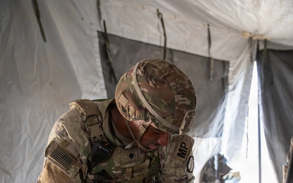 Soldier digs a hole during tent set-up