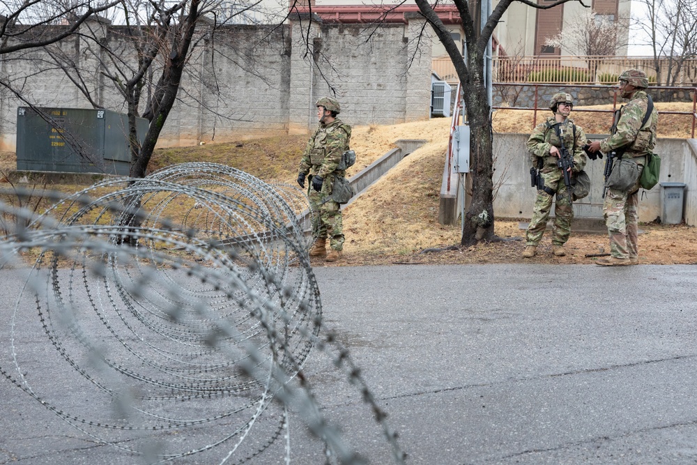MP Soldiers wait for vehicles at entry checkpoint