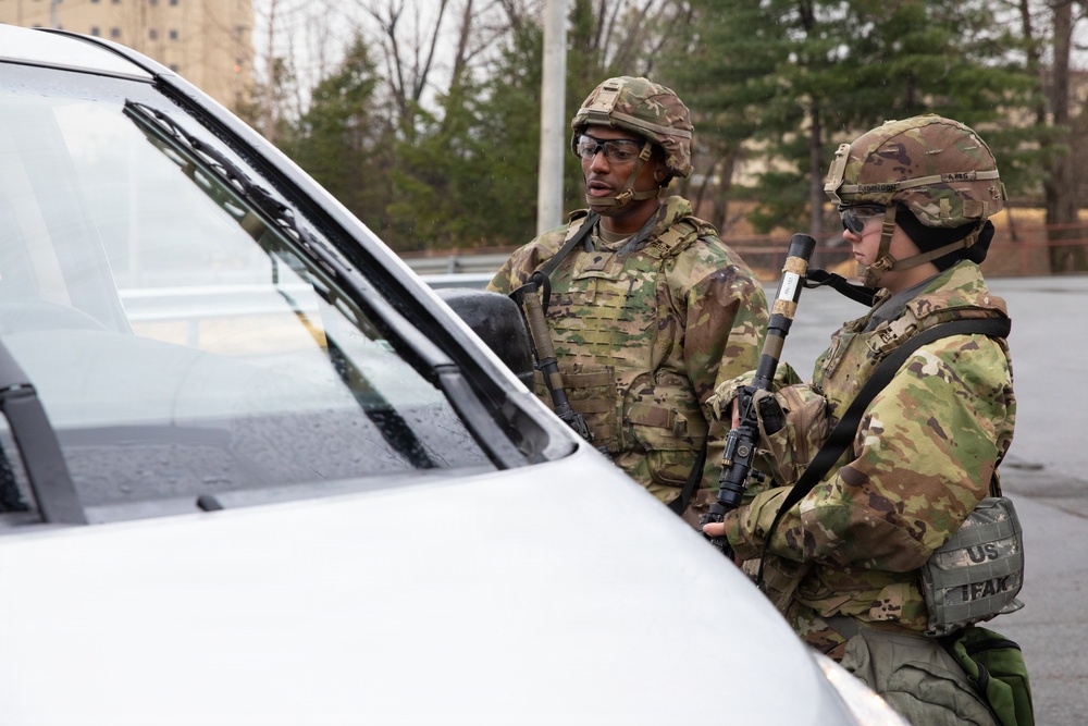 MP Soldiers question driver at entry checkpoint