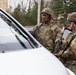 MP Soldiers question driver at entry checkpoint