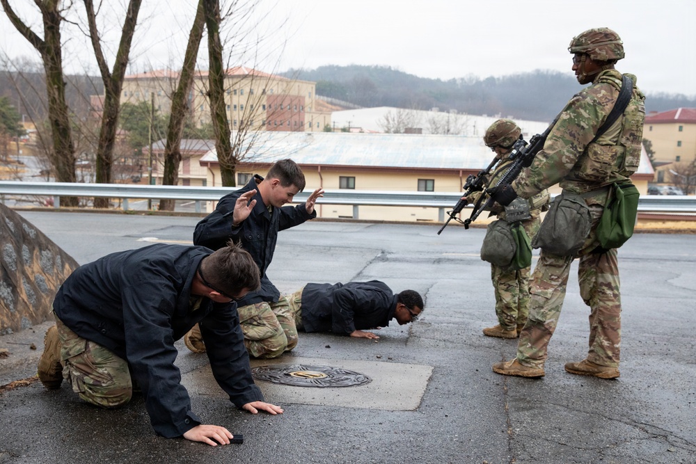 MP Soldiers give commands to simulated detainees
