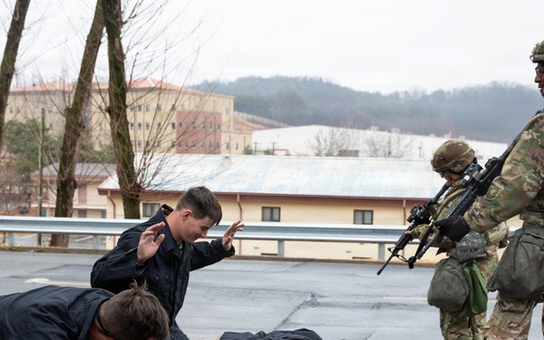 MP Soldiers give commands to simulated detainees