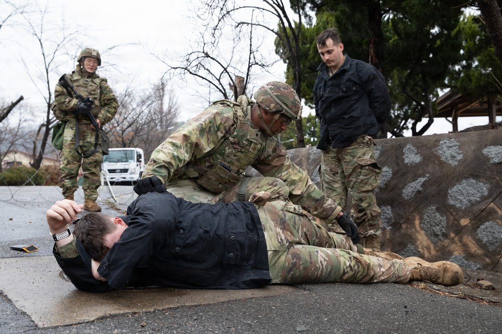 MP Soldier searches simulated detainee