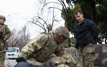 MP Soldier searches simulated detainee