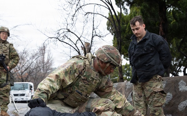 MP Soldier searches simulated detainee