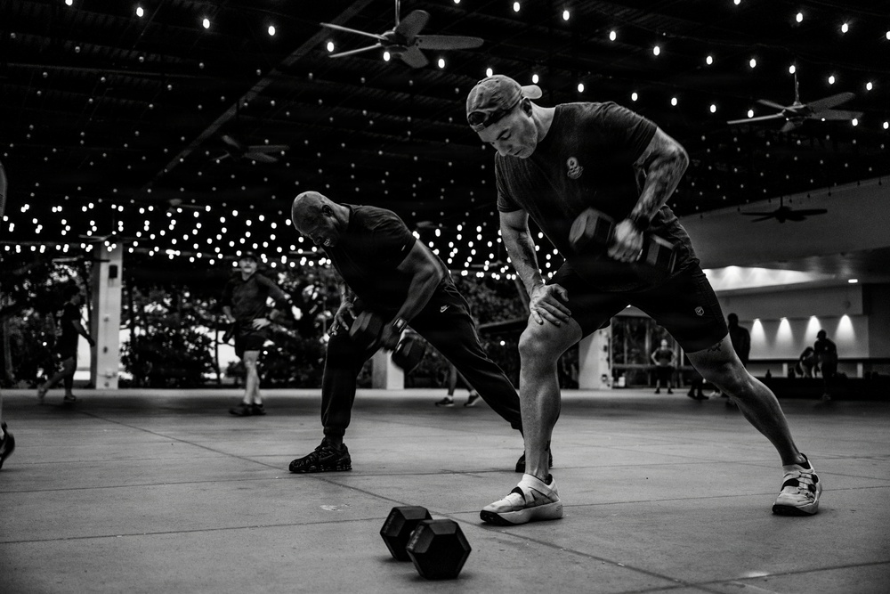 Team Hickam's 647th Security Forces Squadron and 15th Operational Support Team conduct group physical training