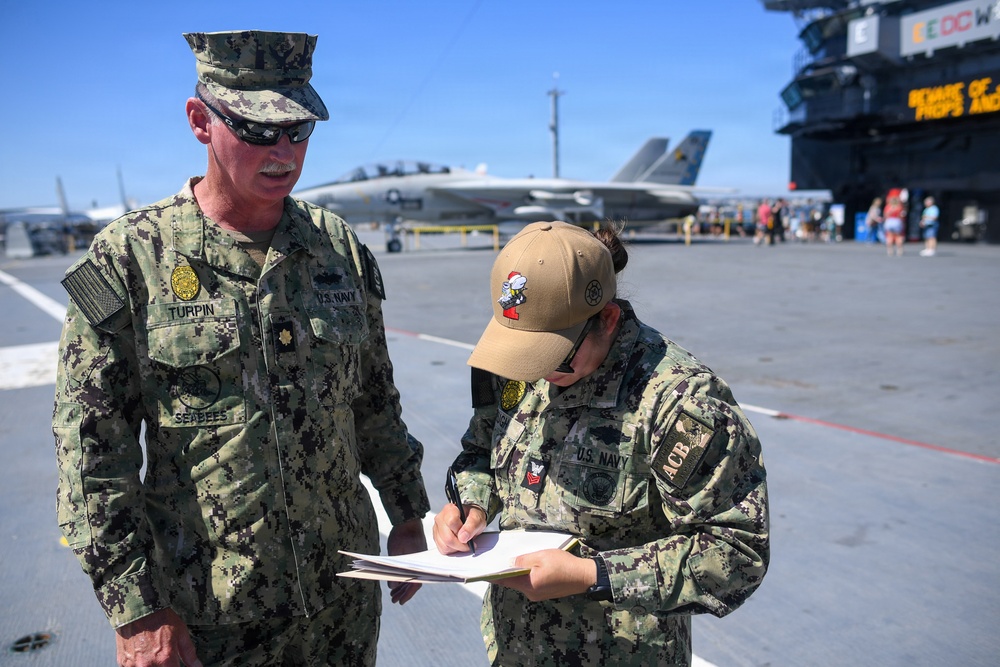 Master-at-Arms 1st Class Jovelyn Peugh reenlists aboard historic USS Midway Museum
