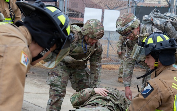Military Intelligence Soldiers Partner with Garrison Firefighters During Simulated Mass Casualty Exercise