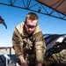 Weapons backshop inspects a gun on an F-16 Fighting Falcon