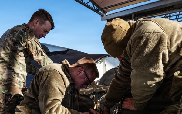 Weapons backshop inspects a gun on an F-16 Fighting Falcon