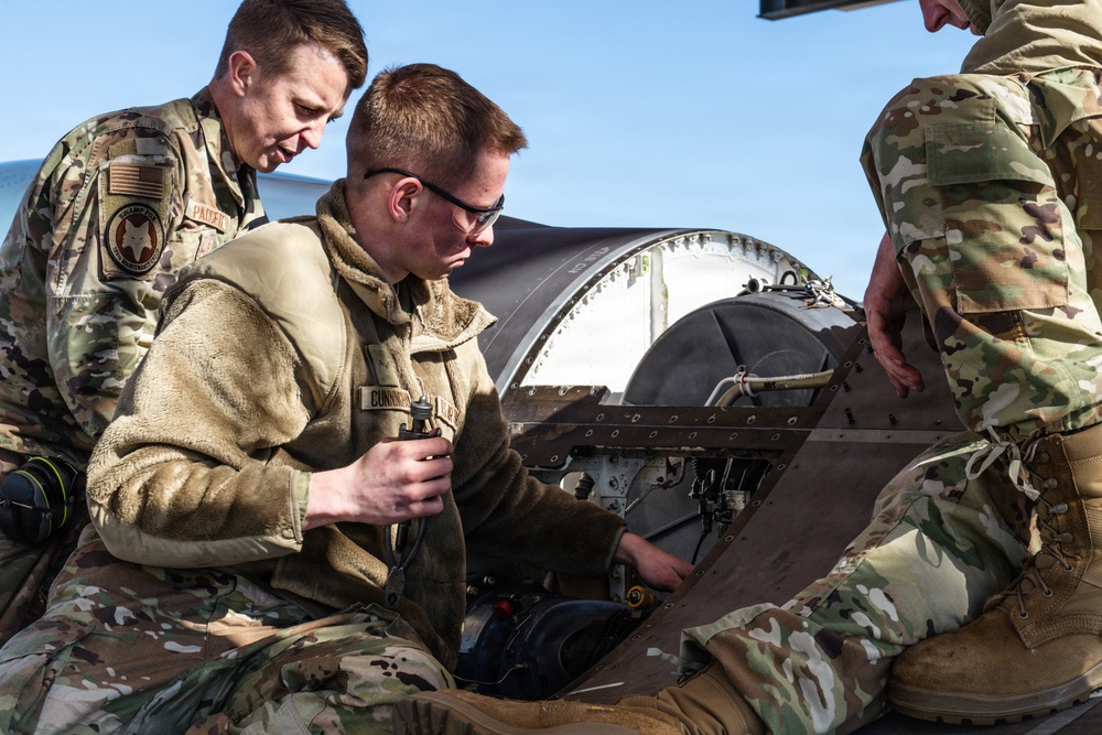 Weapons backshop inspects a gun on an F-16 Fighting Falcon