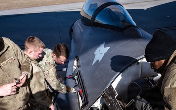 Weapons backshop inspects a gun on an F-16 Fighting Falcon