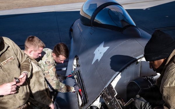 Weapons backshop inspects a gun on an F-16 Fighting Falcon
