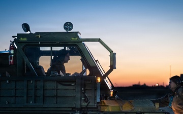 374 LRS loads heavy equipment during BM26