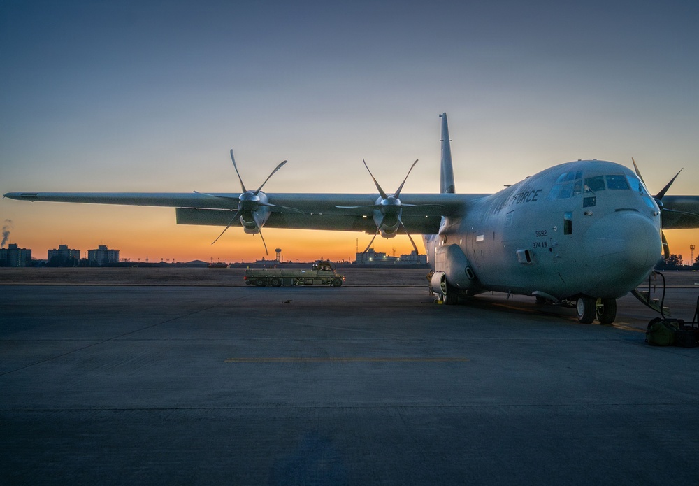 374 LRS loads heavy equipment during BM26