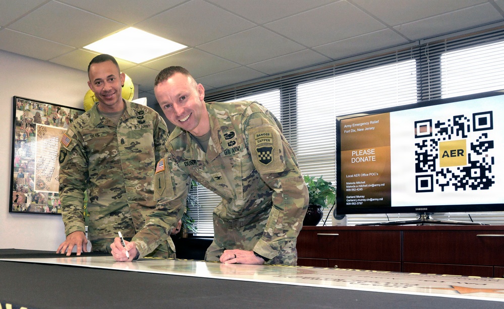 JB MDL leaders sign ceremonial check at AER kick-off