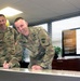 JB MDL leaders sign ceremonial check at AER kick-off