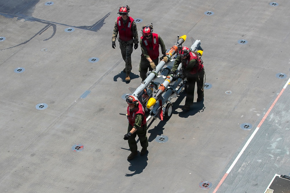 U.S. Marines Assigned to USS Tripoli Transport Ordinance