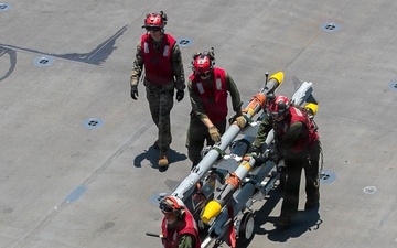 U.S. Marines Assigned to USS Tripoli Transport Ordinance