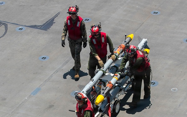 U.S. Marines Assigned to USS Tripoli Transport Ordinance