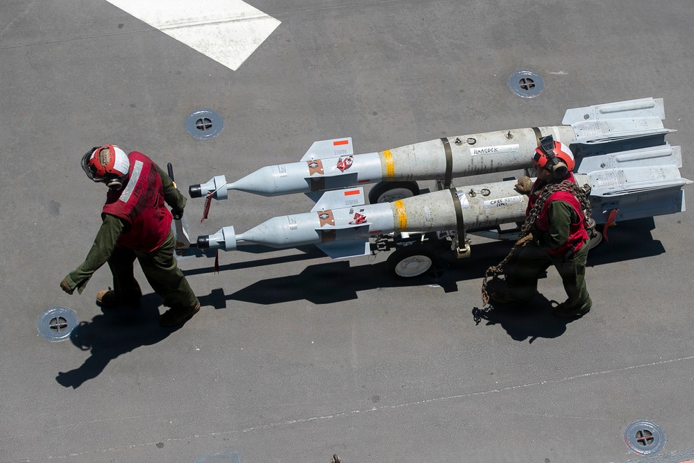 U.S. Marines Assigned to USS Tripoli Transport Ordinance