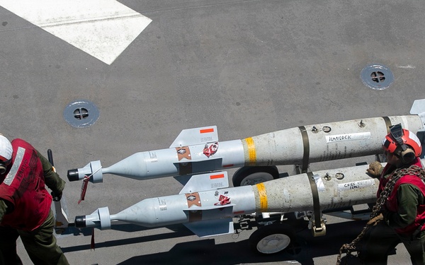 U.S. Marines Assigned to USS Tripoli Transport Ordinance