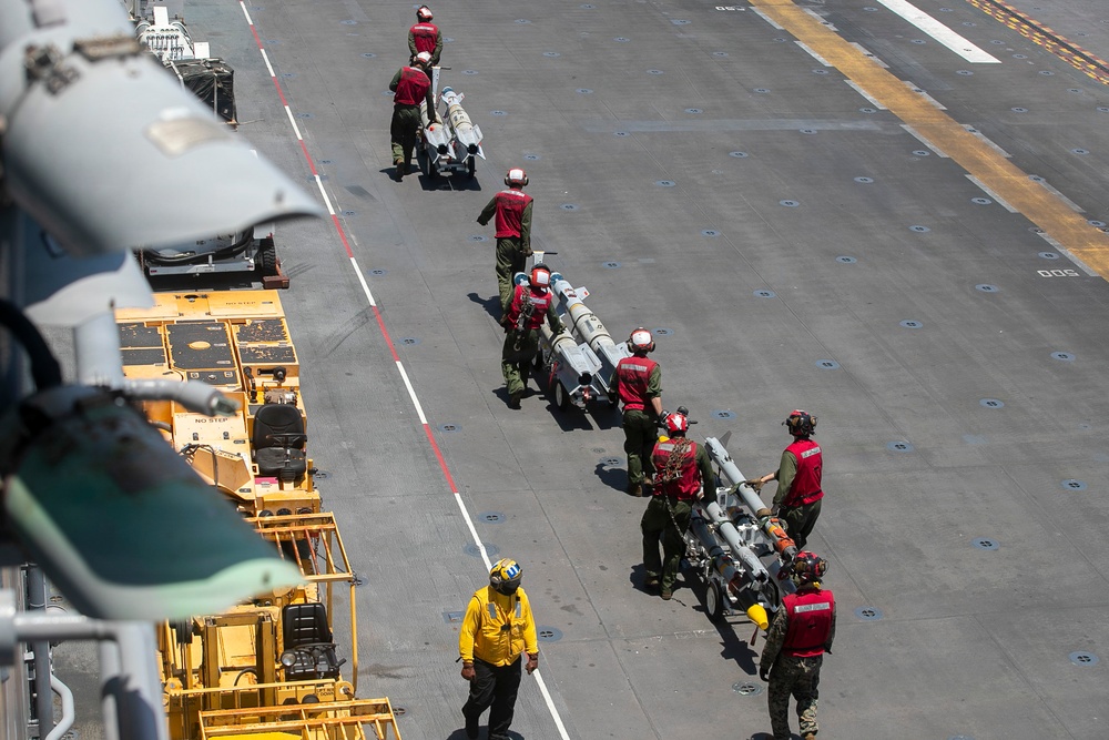 U.S. Marines Assigned to USS Tripoli Transport Ordinance