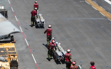 U.S. Marines Assigned to USS Tripoli Transport Ordinance