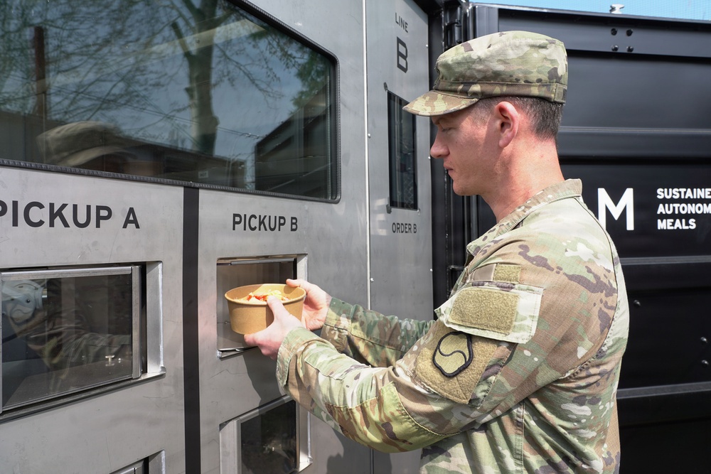 Soldier retrieves meal from autonomous kitchen