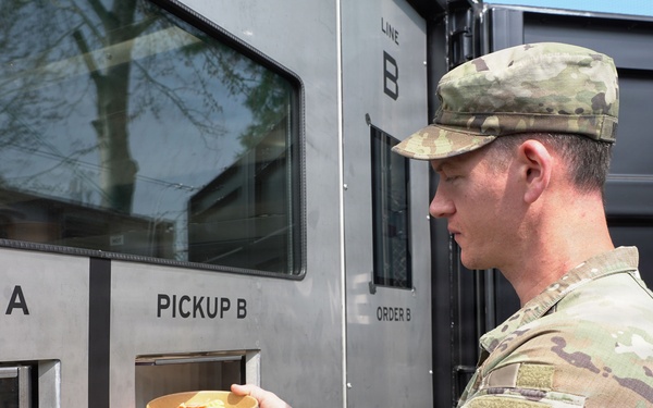 Soldier retrieves meal from autonomous kitchen