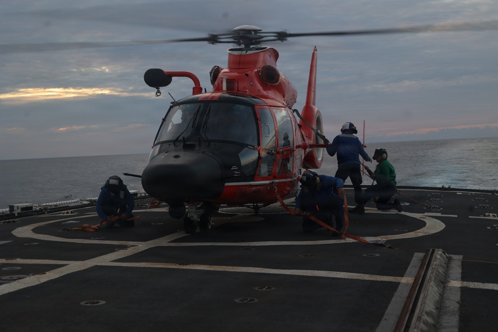 Coast Guard Cutter Forward crew members fuel embarked helicopter at sea