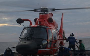 Coast Guard Cutter Forward crew members fuel embarked helicopter at sea