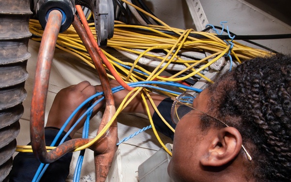 Sailor Runs Cables to Support Shipboard Systems