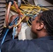 Sailor Runs Cables to Support Shipboard Systems