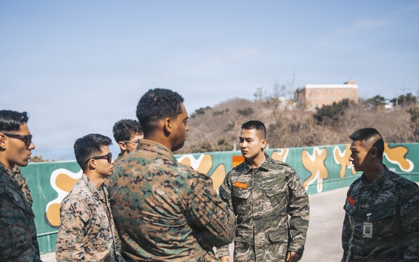 5th Air Naval Gunfire Liaison Company Marines, Republic of Korea service members conduct communications setup and weapons familiarization during Freedom Shield 26
