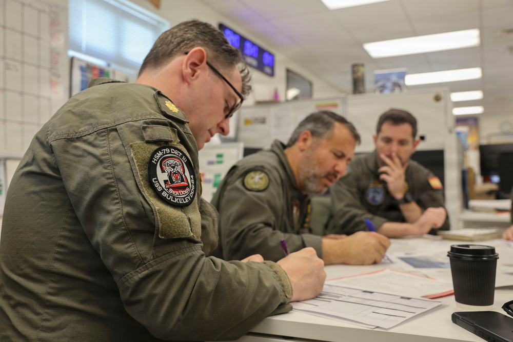 U.S. Navy service members from HSM-79 conduct interoperability planning with the Spanish Armada.