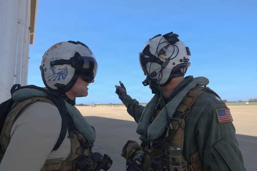 HSM-79 Commanding Officer Cmdr. Alex Haupt discusses pre-flight safety checks with Lt. Cmdr. Kyle O’Connell