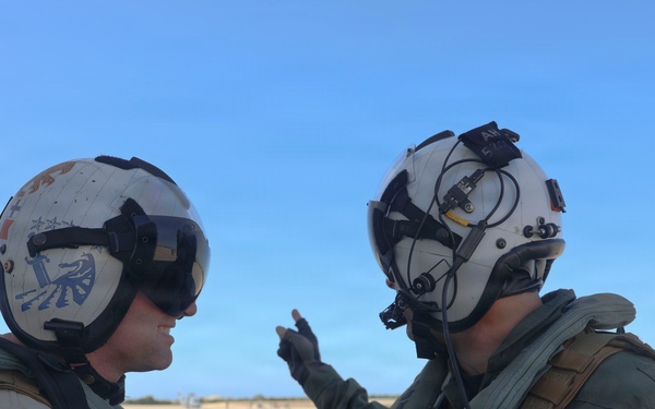 HSM-79 Commanding Officer Cmdr. Alex Haupt discusses pre-flight safety checks with Lt. Cmdr. Kyle O’Connell