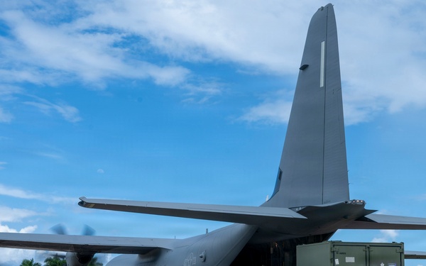 346th Air Expeditionary Wing unloads cargo off a C-130J