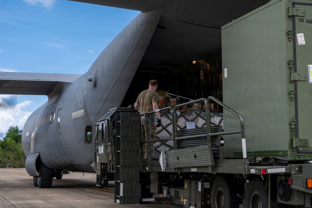 346th Air Expeditionary Wing unloads cargo off a C-130J